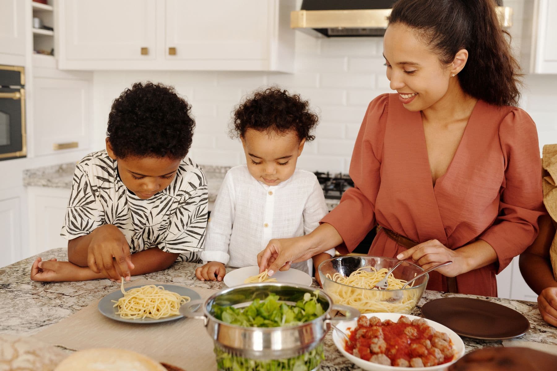A mother serving dinner to her children at the family table